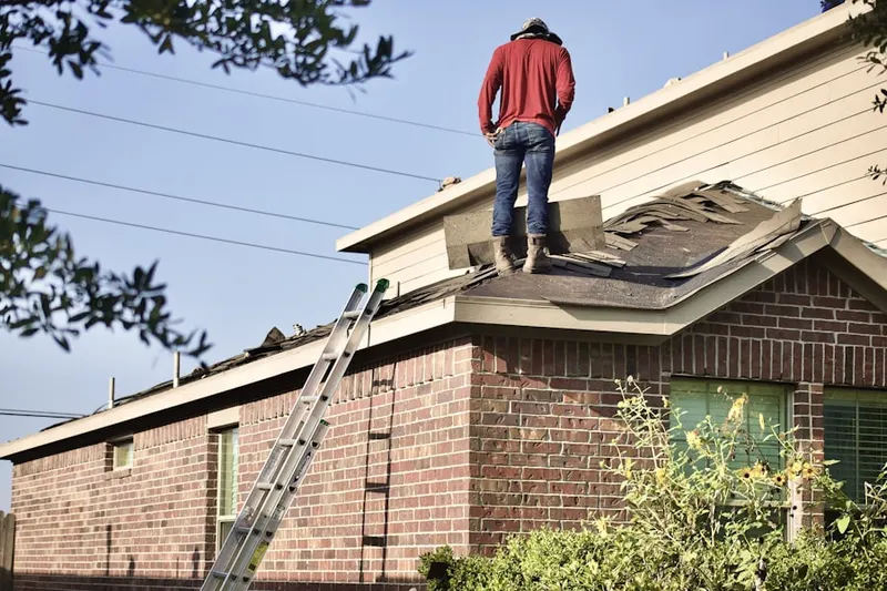 Professional roofer working on a residential roof in Jennings